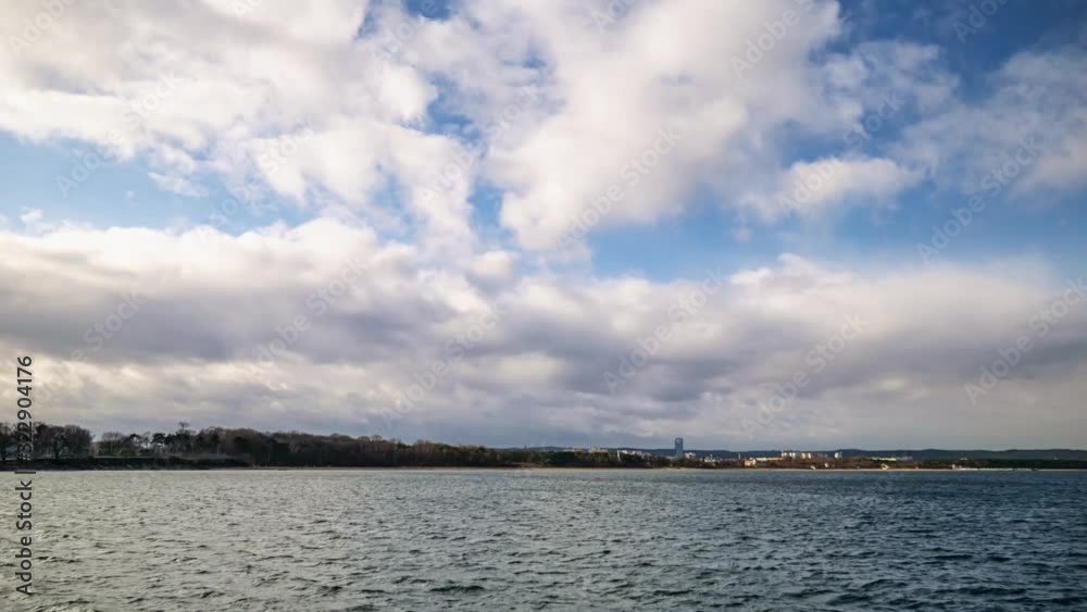Clouds Over Sea Timelapse. Clouds Rolling Over Sea And Coastline of Baltic Sea in Gdansk Poland. Storm Clouds And Blue Sky. Clouds Over Sea Timelapse. Clouds Rolling Over Sea And Coastline of Baltic Sea in Gdansk Poland. Storm Clouds And Blue Sky.