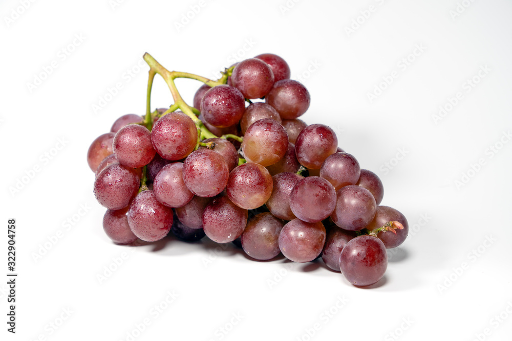 Purple grapes on white background..