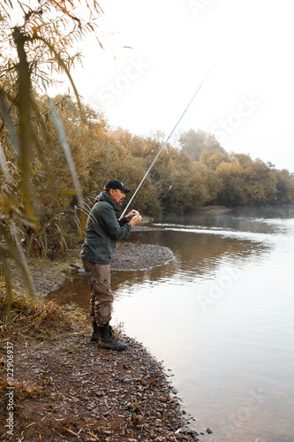 A man is fishing on the river. Fisherman on a morning fishing trip © ProstoSvet