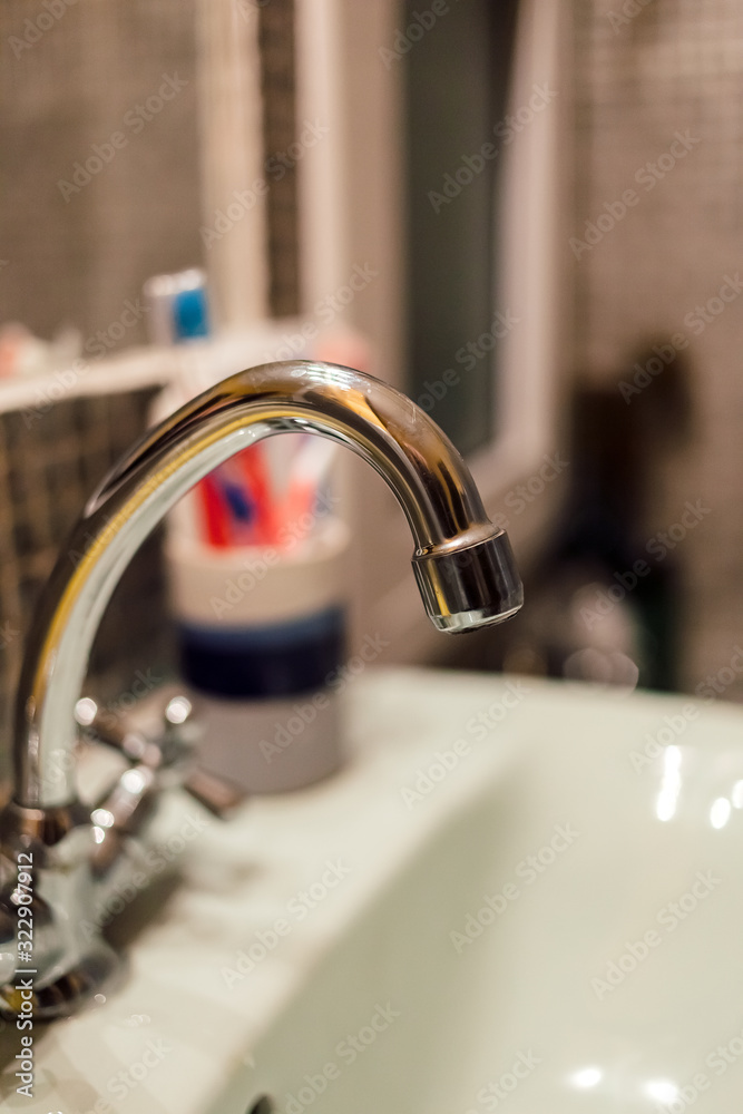metal faucet at wash basin, Interior of bathroom - close up metal faucet at wash basin, Interior of bathroom - close up