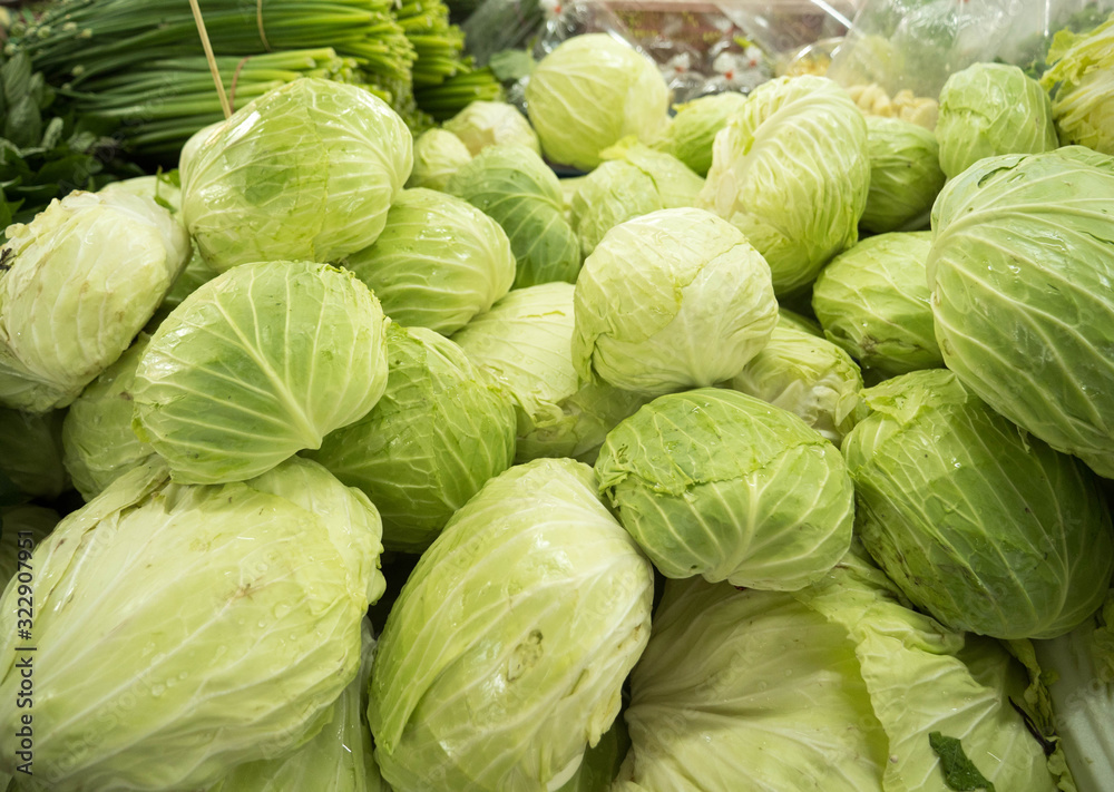 Fresh green cabbage on the market stall selling vegetables Fresh green cabbage on the market stall selling vegetables