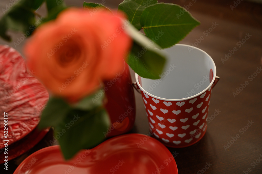 Fototapeta premium Valentines hearts, candy, and flowers. Motion blur movements and flowers on a vase.