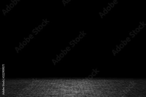 Light shining down on gray carpet floor in dark room with copy space, abstract background