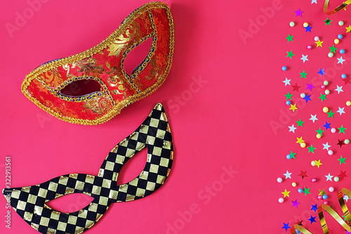 Festive masks with decor on a red background. Carnival celebration concept, Mardi Gras, Brazilian carnival, Venice Carnival, carnival costume, spring. Flat lay, top view, place for text