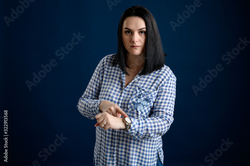 Beautiful woman dressed casually showing time on her watch