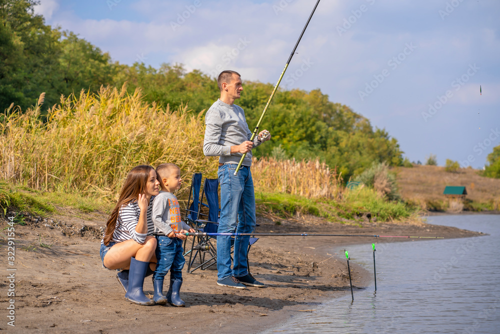 A happy family spends time together they teach their son to fish. A happy family spends time together they teach their son to fish.