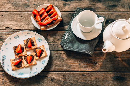 cup of tea and dessert on wooden table