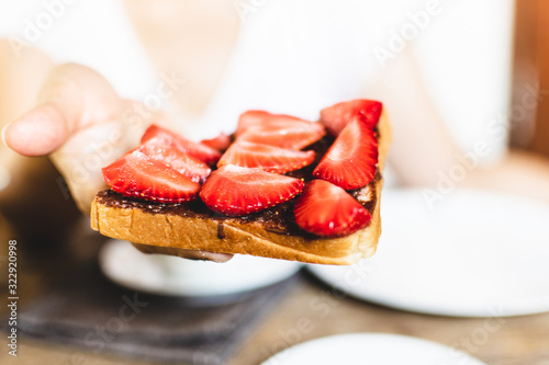 sandwich with sliced strawberries and chocolate. 