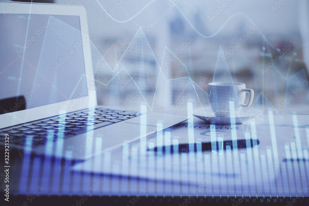 Forex graph hologram on table with computer background. Double exposure. Concept of financial markets. Forex graph hologram on table with computer background. Double exposure. Concept of financial markets.
