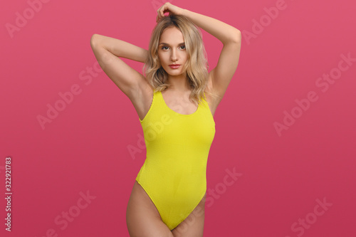 Beautiful sexy young woman in yellow swimsuit