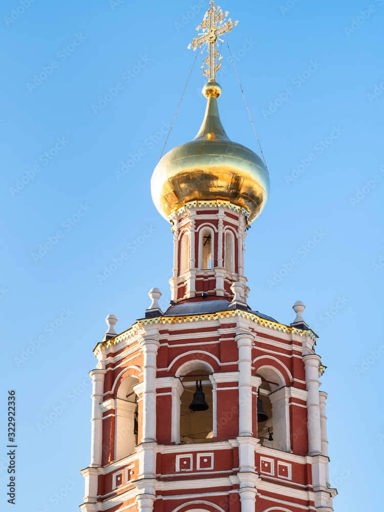 bell tower of Church lit by morning sun in Moscow