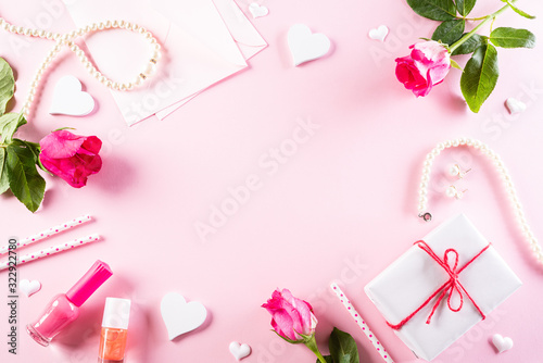 International Women's Day concept. Woman lace lingerie jewelry perfume present with pink roses on bright pink pastel background. flat lay, March 8. © Siam