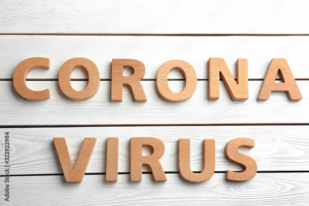 Words CORONA VIRUS made with wooden letters on white background, flat lay Words CORONA VIRUS made with wooden letters on white background, flat lay