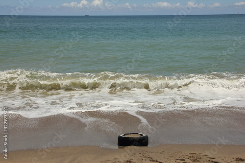 A tire trash found in the during International Coastal beach cleanup day activity in La Guaira. Plastic from tyres major source of ocean pollution. photo