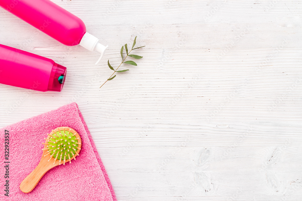 Hair care set with shampoo and towel - pink - on whiite background top-down frame copy space Hair care set with shampoo and towel - pink - on whiite background top-down frame copy space