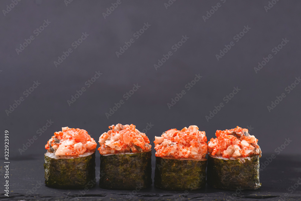 Set of four pieces of spicy Maki sushi rolls with sauced slices of smoked Eel, cheese and caviar of flying fish. Set of four pieces of spicy Maki sushi rolls with sauced slices of smoked Eel, cheese and caviar of flying fish.
