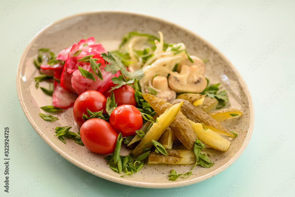 Vegetable veggies salad with pickles, cherry tomatoes, mushrooms and red cabbage served in white plate Vegetable veggies salad with pickles, cherry tomatoes, mushrooms and red cabbage served in white plate