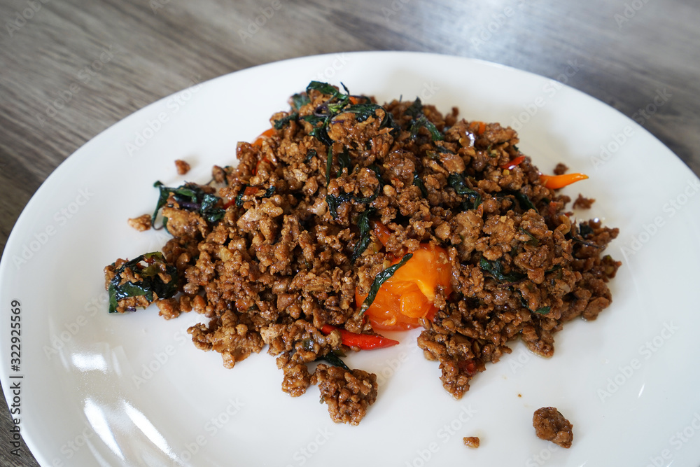 Close up Stir fried Thai holy basil with minced pork and a salted egg Close up Stir fried Thai holy basil with minced pork and a salted egg