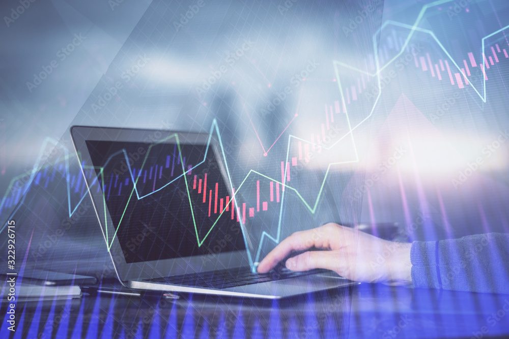Double exposure of stock market graph with man working on laptop on background. Concept of financial analysis. Double exposure of stock market graph with man working on laptop on background. Concept of financial analysis.