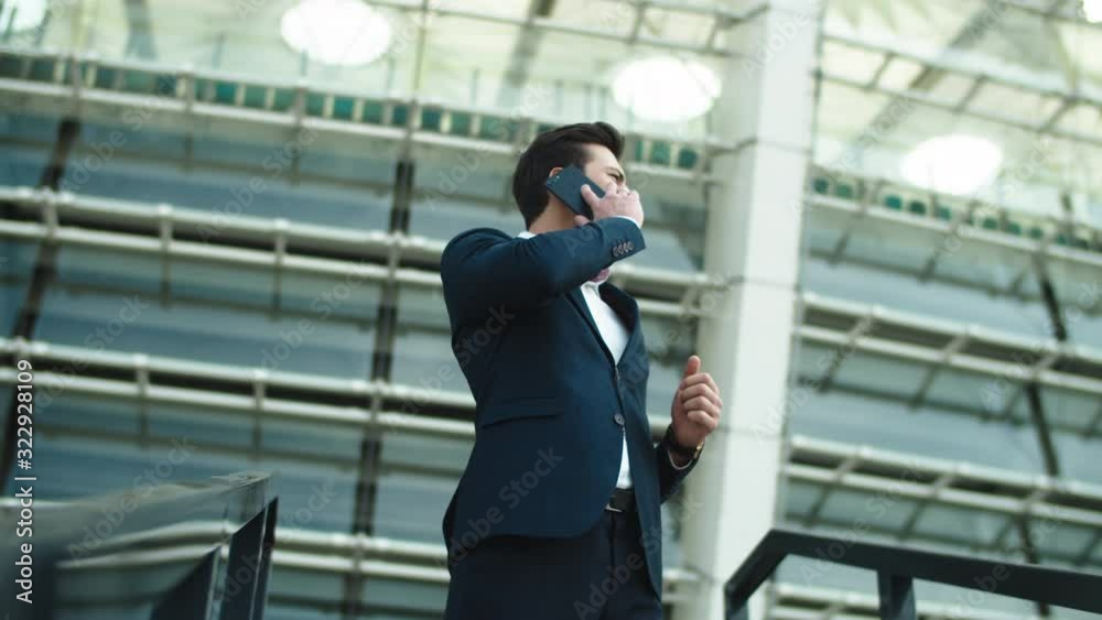 Closeup businessman talking smartphone. Businessman smiling with phone outdoors Closeup businessman talking smartphone. Businessman smiling with phone outdoors