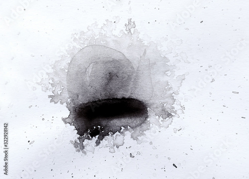 abstract black splashes on white watercolor paper. monochrome image.