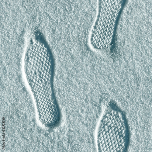 Seamless texture of flat surface covered with thin layer of fresh snow with footprints. Minsk. Belarus.