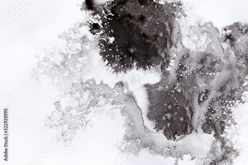 abstract black splashes on white watercolor paper. monochrome image.