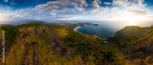 Aerial panorama of Phuket island in Thailand. Aerial panorama of the southern area of the island of Phuket with Nai Harn beach (in the center) during sunset © Dudarev Mikhail