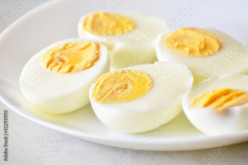 Boiled egg on a white plate. Selective focus at the front piece of egg and leave the back and another part of the photo blurry. Soft focus.