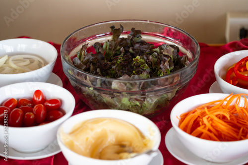 Variety of fresh vegetables and dressing salad.