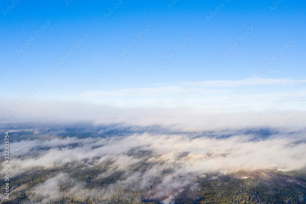 Aerial view clouds over forest. Aerial view of forest and clouds. Aerial drone view flying over the forest. Aerial top view cloudscape. Texture of clouds
