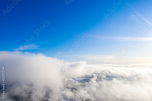 Aerial view clouds over forest. Aerial view of forest and clouds. Aerial drone view flying over the forest. Aerial top view cloudscape. Texture of clouds