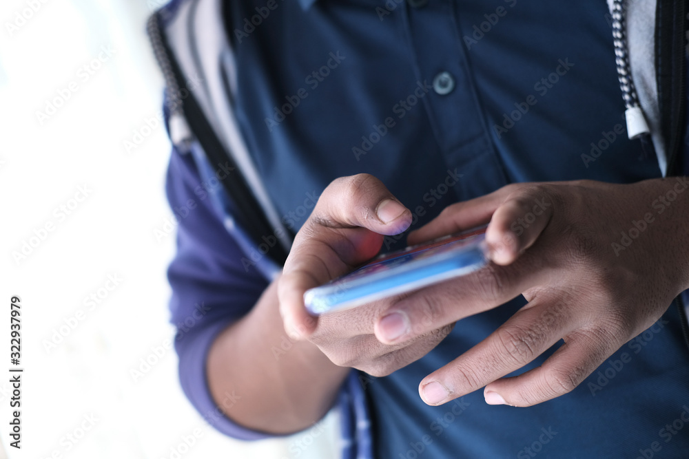 close up of young man use smart phone texting message