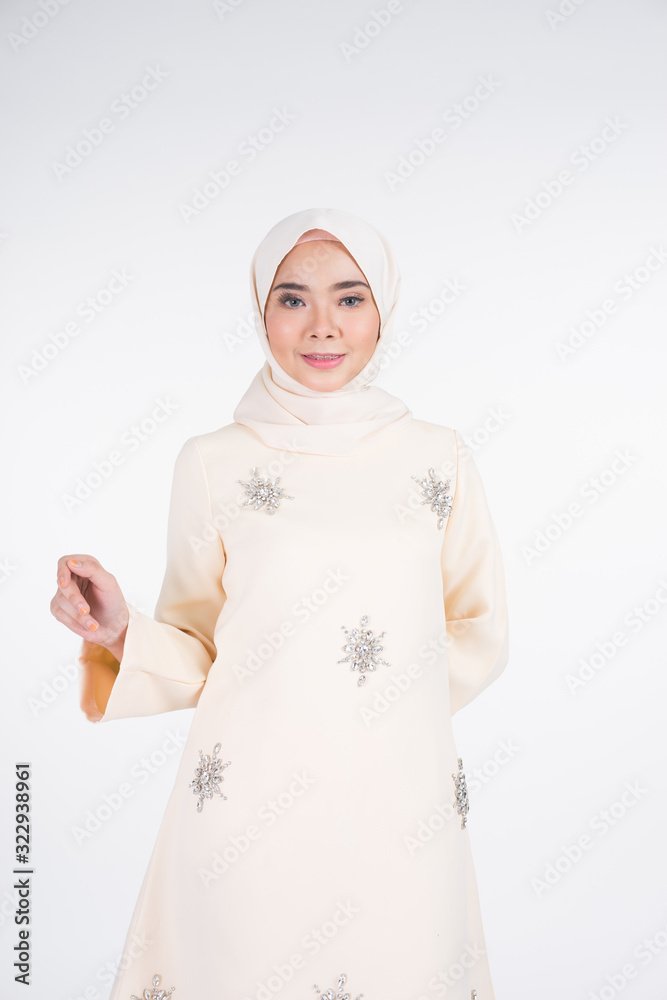 Beautiful female Muslim model in various poses wearing kurung Pahang and hijab, a lifestyle apparel for Muslim women isolated on white. Beauty and hijab fashion concept. Half length portrait Beautiful female Muslim model in various poses wearing kurung Pahang and hijab, a lifestyle apparel for Muslim women isolated on white. Beauty and hijab fashion concept. Half length portrait