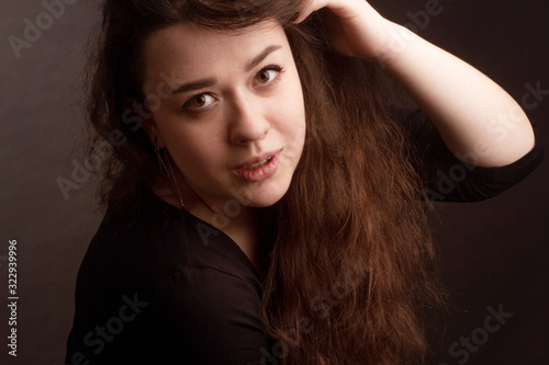 portrait of a brunette with long curly hair