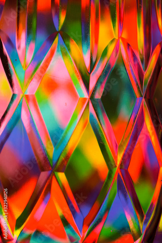 Abstract background of a bright colors through a diamond pattern lead crystal glass vase 