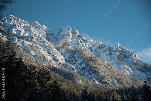 Mountains covered with snow blanket shot on sunny day
