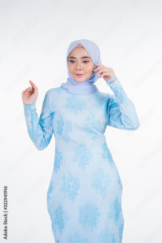 Beautiful Muslim female model wearing pastel blue modern kurung with hijab, a urban lifestyle apparel for Muslim women isolated on white background. Beauty and hijab fashion concept. Half length Beautiful Muslim female model wearing pastel blue modern kurung with hijab, a urban lifestyle apparel for Muslim women isolated on white background. Beauty and hijab fashion concept. Half length