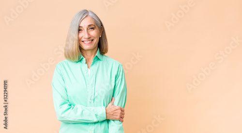 Obraz na plátně middle age cool woman laughing shyly and cheerfully, with a friendly and positiv