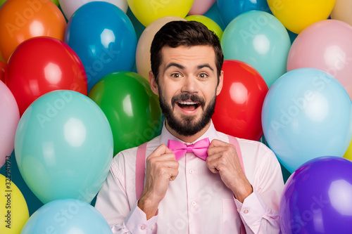 Photo of funny guy colorful design ready for birthday party surprise good mood formalwear pink shirt bow tie suspenders on vivid bright many balloons creative background © deagreez