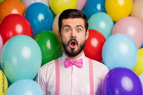Photo of funny handsome guy open mouth colorful design atmosphere surprised birthday party formalwear pink shirt bow tie suspenders on bright many balloons creative background