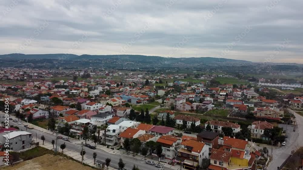 Flying towards the city, old houses, cars.
City of İzmir, İskele Turkey. Flying towards the city, old houses, cars.
City of İzmir, İskele Turkey.