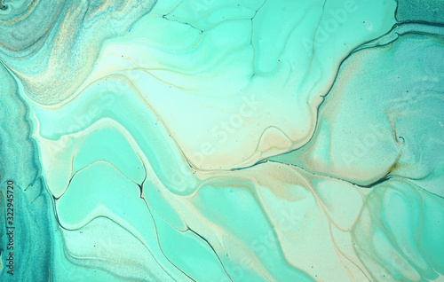 Very beautiful abstract ART background - random free mixing of paints in technique of liquid acrylic. Artistic image of swirl veins marble texture in turquoise beige tones.