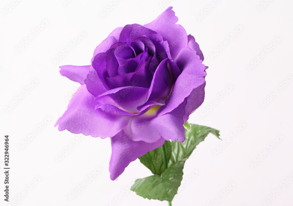 Artificial violet roses on white background Artificial violet roses on white background