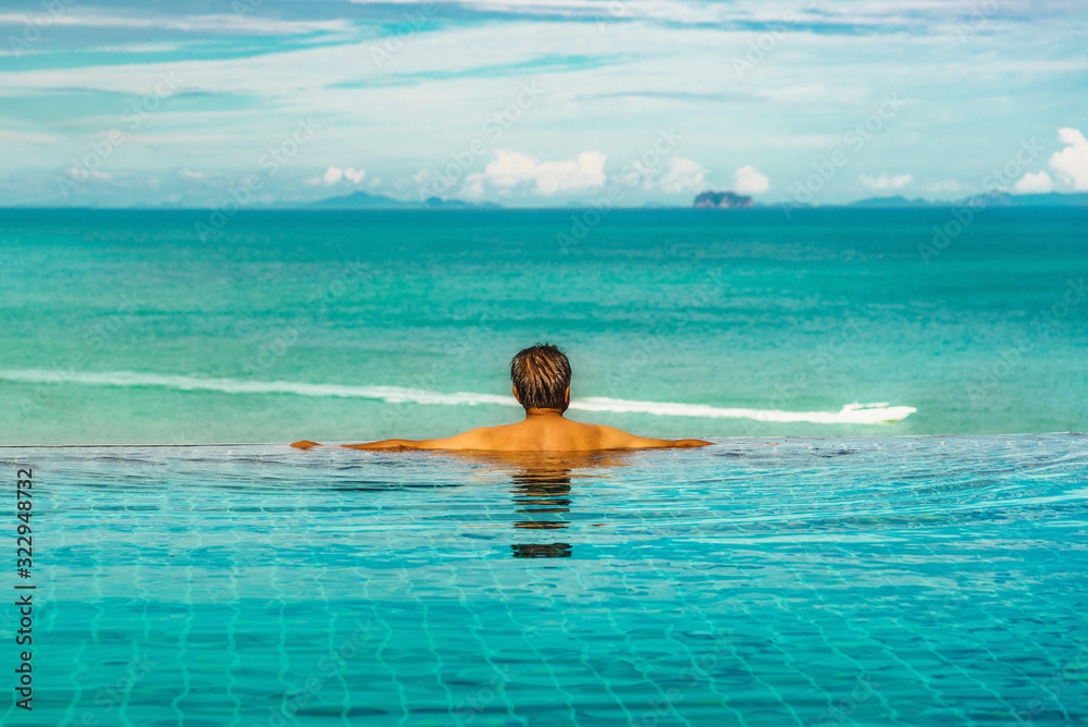 Success business man private relaxing in resort luxury swimming pool in front of sea beach, Leisure tourist travel Phuket Thailand summer holiday vacation trip Tourism beautiful destination place Asia