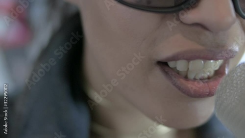 A singer sings in a microphone. Closeup. Singer: Marlene Johnson photo