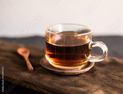 Hot tea with spoon wood on woo table. photo