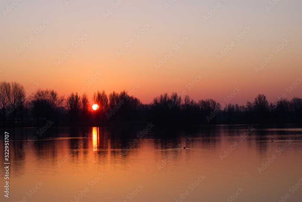 Fototapeta premium Sunrise above a lake in Arnhem called: Rijkerswoerdse plassen in the Netherlands