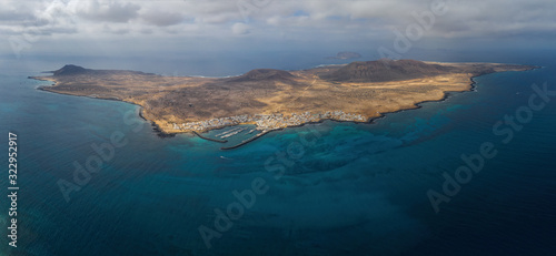 Panoramic aerial view on island of La Graciosa with blue sky and splendid sea. October 2019