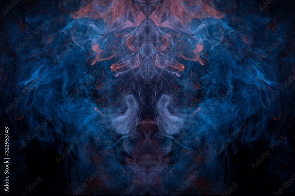Fantasy print for clothes: t-shirts, sweatshirts.  Colorful blue and orange  smoke in the form of a skull, monster, dragon on a black isolated background. Background from the smoke of vape.